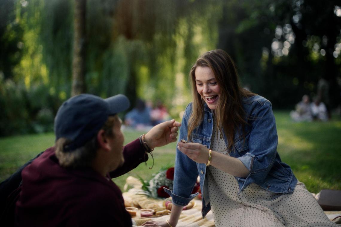 vrouw krijgt een ring van vriend tijdens picknick